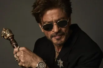 Shah Rukh Khan in a Sabyasachi ensemble at the Met Gala wearing layered jewellery and carrying a tiger-head cane