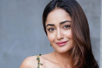 Tridha Choudhury in a vibrant green saree with a striking red border and embroidered blouse