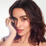 Shraddha Kapoor wearing a beige crochet top with layered gold jewellery in a sun-kissed fashion shoot