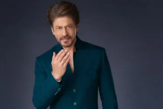 Shah Rukh Khan wearing an emerald green achkan with black draped trousers for Eid