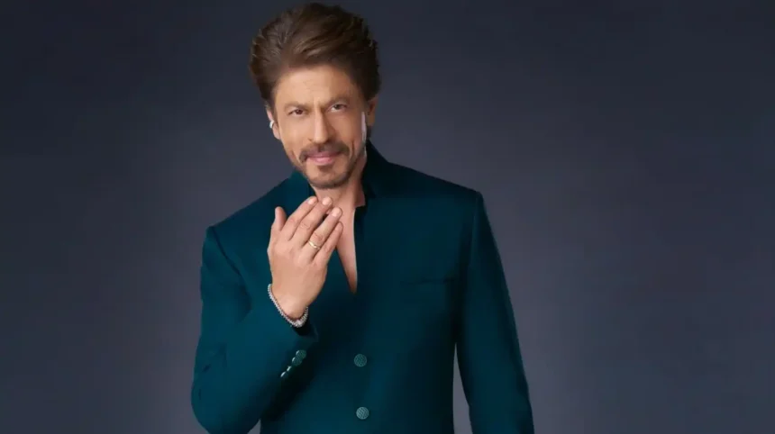 Shah Rukh Khan wearing an emerald green achkan with black draped trousers for Eid