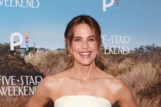 Jennifer Garner wearing a floral Prada midi skirt, black sweater and Chanel strappy heels in Santa Monica