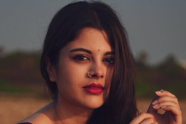 Sanjana Krishnamoorthy wearing a deep maroon handloom saree by the sea