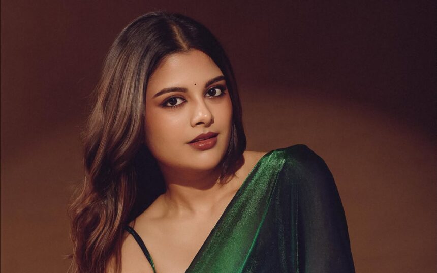Sanjana AK in an emerald green saree styled by Deekshita Nikkam