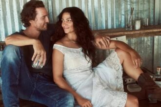 Matthew McConaughey and Camila Alves smiling together at an event