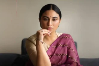 Priya Malik speaking at a poetry performance event on stage