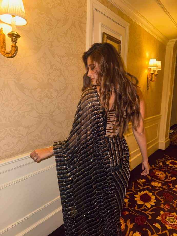 Hunterfly rasha thadani keeps it glam in a black shimmery saree