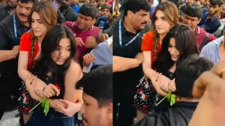 Kriti Sanon guiding Rashmika Mandanna through a crowd during a Cocktail 2 promotional event