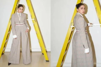 Sharvari wearing a tailored plaid corporatecore suit with tie and wide-leg trousers