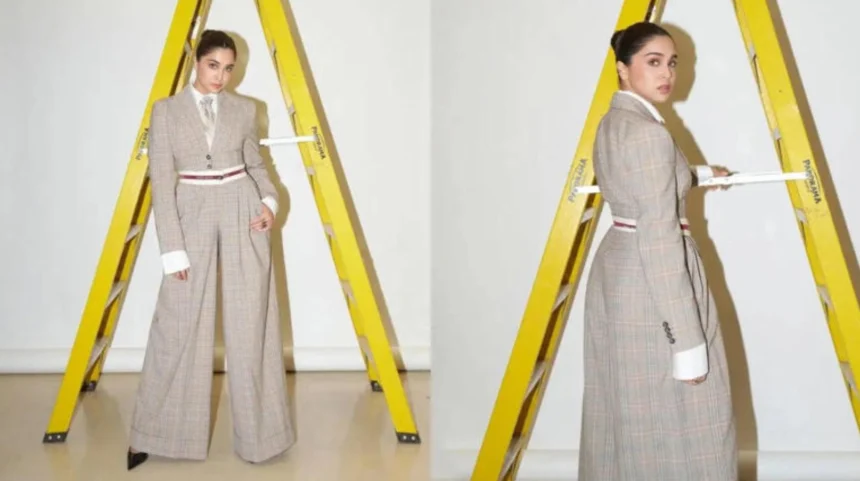 Sharvari wearing a tailored plaid corporatecore suit with tie and wide-leg trousers