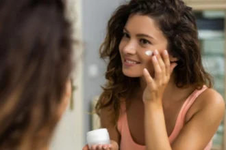 Minimal skincare products arranged beside a moisturizer and sunscreen representing the skinimalism trend