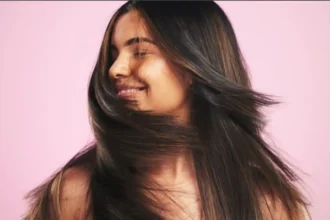 Hunterfly 26 06 15 154048 11zon Woman applying conditioner to maintain healthy and shiny Indian hair.