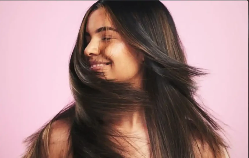 Hunterfly 26 06 15 154048 11zon Woman applying conditioner to maintain healthy and shiny Indian hair.