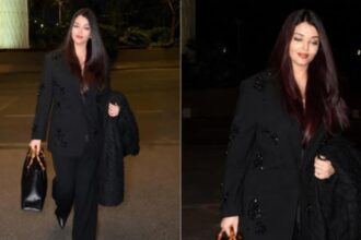 Aishwarya Rai wearing an embellished black pantsuit with a Gucci bag