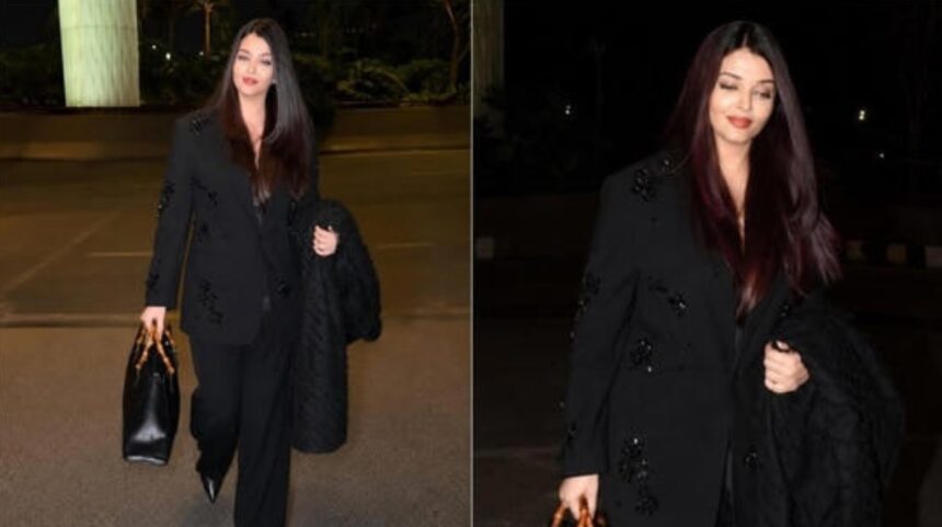 Aishwarya Rai wearing an embellished black pantsuit with a Gucci bag