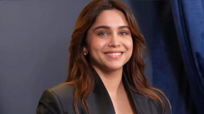 Sharvari wearing an all-black designer outfit with gold accents