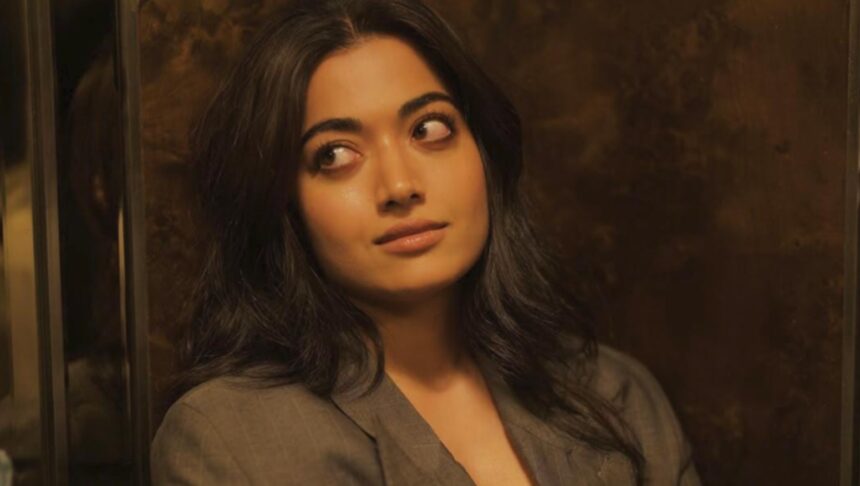 Rashmika Mandanna smiles during a promotional event while speaking about her career journey.