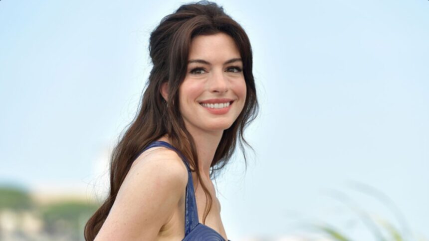 Anne Hathaway reacting on TikTok after learning she wore a red designer jumpsuit backwards.