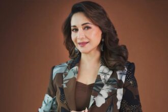 Madhuri Dixit performing ring hanging knee raises during a fitness workout