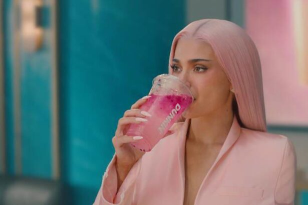 Kylie Jenner promoting Dunkin's King Kylie Collection featuring pink-themed summer beverages.