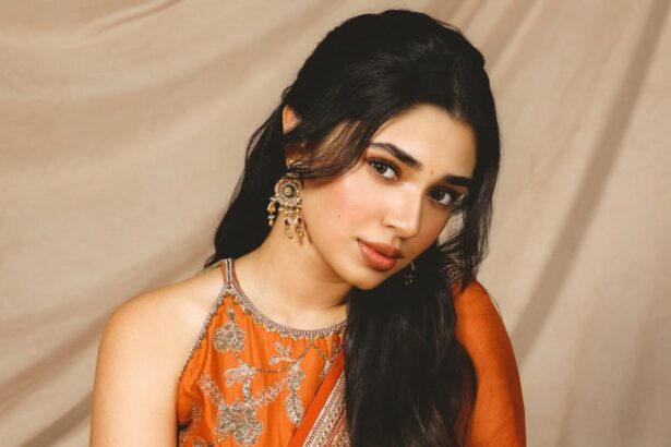 Krithi Shetty wearing a rust-orange ethnic ensemble with gold embroidery