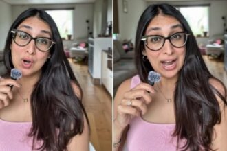 Indian woman working on laptop while caring for baby and building a new business after job loss