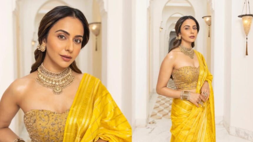 Rakul Preet Singh wearing a yellow silk saree with kundan jewellery at the Ramayana promotional event in New Delhi