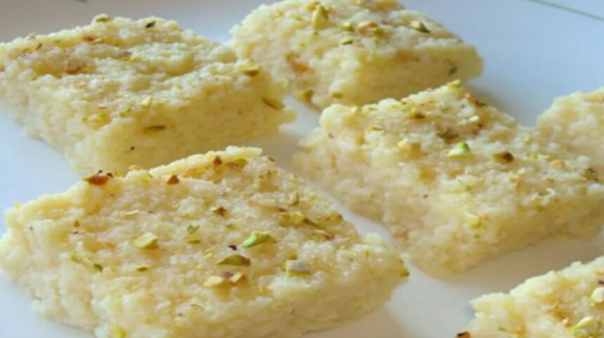Hunterfly 2026 07 25 172445 Homemade Kalakand garnished with chopped pistachios and almonds on a serving plate.