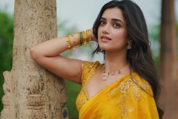Bhagyashri Borse wearing a bright yellow saree during a garden photoshoot
