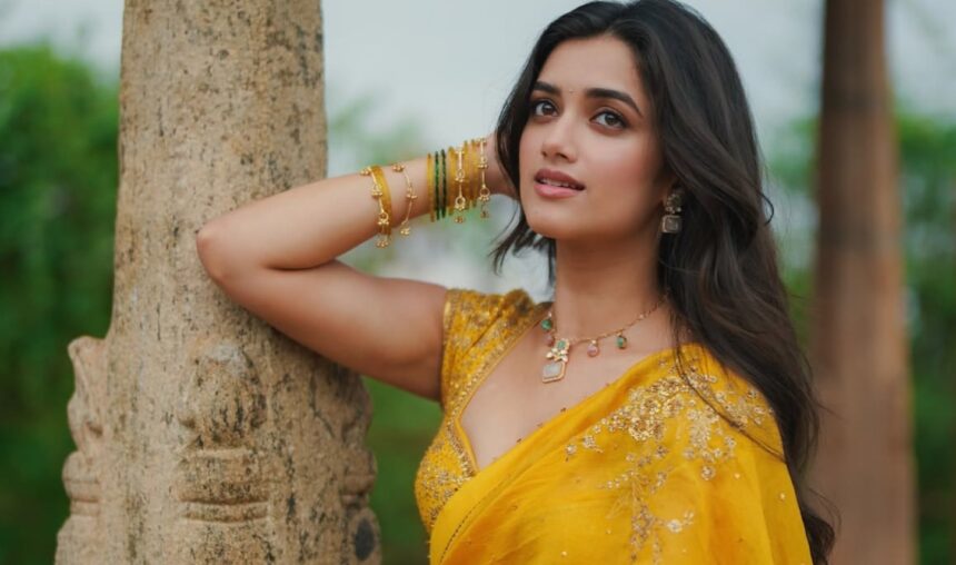 Bhagyashri Borse wearing a bright yellow saree during a garden photoshoot