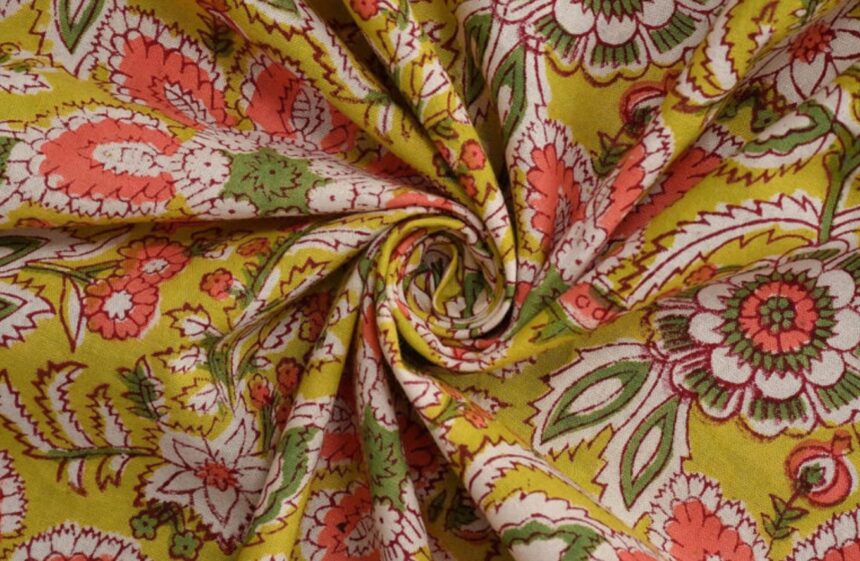 Artisan creating Kalamkari artwork using traditional natural dyes and bamboo pen