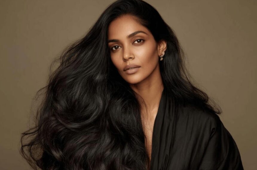 Woman following a personalized haircare routine with scalp-focused products.