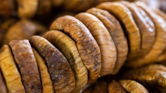 Soaked anjeer figs in a bowl highlighting digestive and heart health benefits