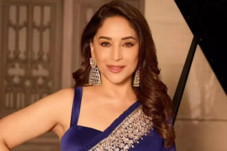 Madhuri Dixit wearing an elegant saree suitable for a monsoon wedding celebration.
