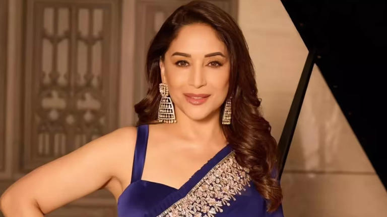 Hunterfly fsdfds Madhuri Dixit wearing an elegant saree suitable for a monsoon wedding celebration.