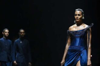 Hunterfly hot 2026 07 18 182429 A model showcasing an elaborate couture creation during Gaurav Gupta's runway presentation featuring sculptural details and dramatic craftsmanship.