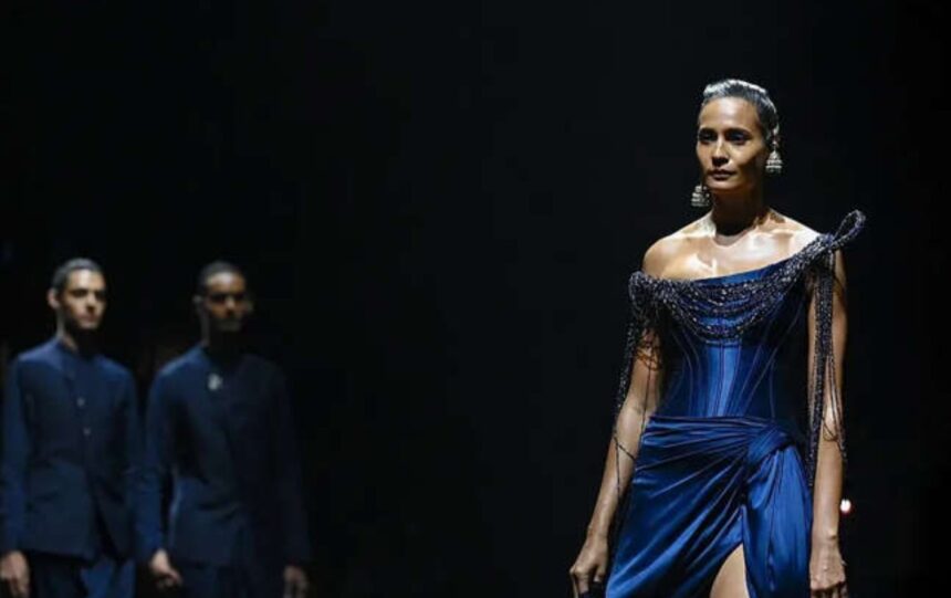 A model showcasing an elaborate couture creation during Gaurav Gupta's runway presentation featuring sculptural details and dramatic craftsmanship.