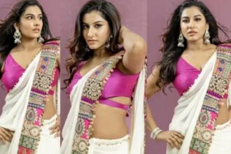 Vishnu Priya wearing a white saree with a sleeveless pink blouse.