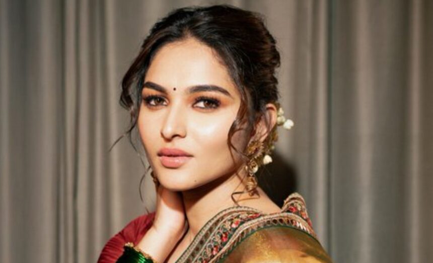 Hunterfly 026 08 07 162415 Kayadu Lohar wearing a golden tissue-organza saree with a maroon blouse and traditional jewellery during a fashion photoshoot.