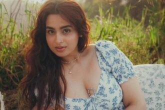 Ayesha Khan poses with a mystery man while showing a diamond ring