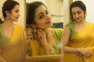 Trisha Krishnan in a yellow saree and green blouse with jasmine flowers