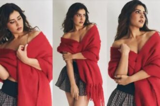 Raashi Khanna poses in a glamorous short skirt and vibrant red shawl during a fashion photoshoot