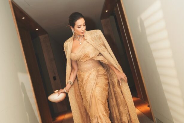 Malaika Arora wearing a champagne-gold saree with a dramatic statement jacket at the Melbourne Film Festival
