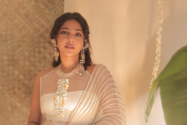 Aishwarya Lekshmi wearing a contemporary ivory festive outfit with jasmine flowers during an Onam-themed photoshoot.