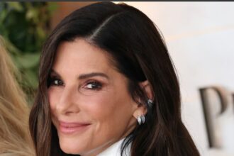 Sandra Bullock with her two adopted children Louis and Laila in a family-themed editorial image