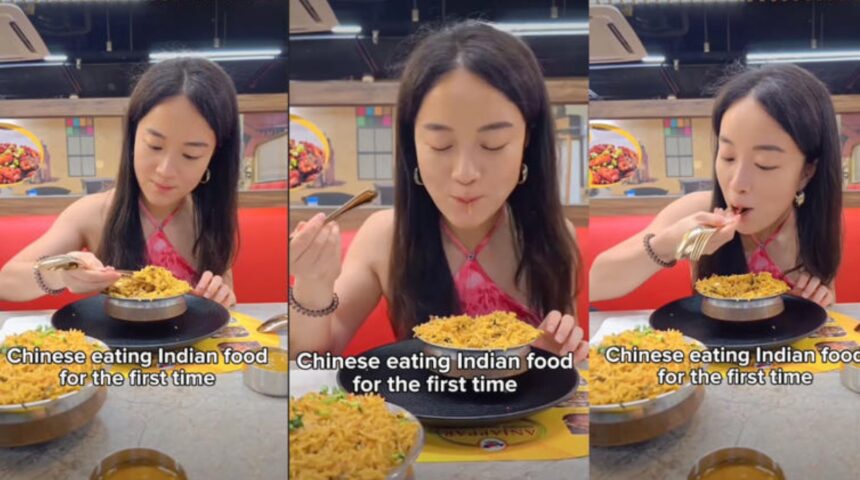 Chinese woman trying biryani for the first time while using a spoon like chopsticks
