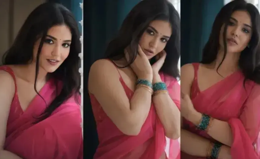 Priyanka Jawalkar in a vibrant pink saree and matching sleeveless blouse