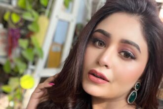 Ritabhari Chakraborty in a turquoise bikini top and red floral sarong by a pool