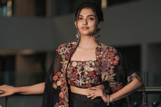 Mamitha Baiju at a film event smiling for photographers