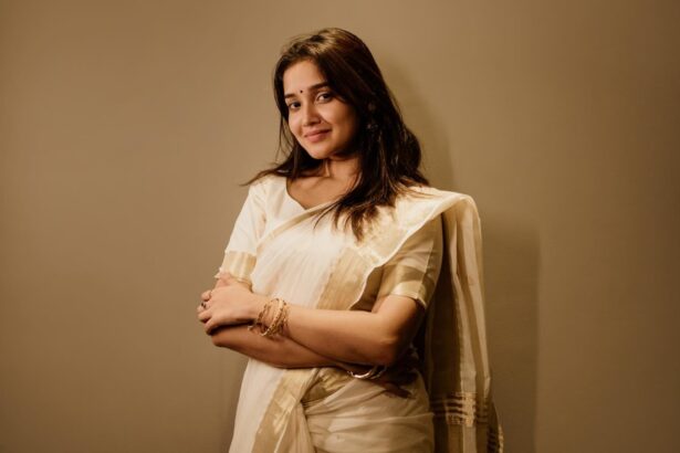 Anikha Surendran in a traditional white saree with a golden border for Vishu